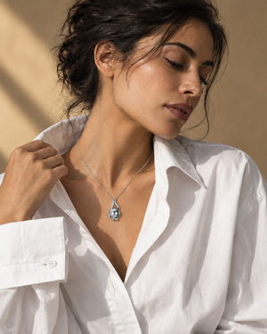 Silver-tone grey orb necklace worn with neutral clothing