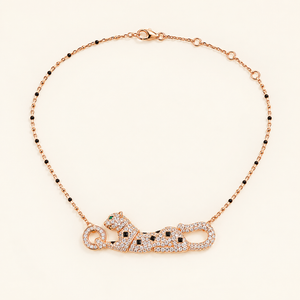 Rose Gold-tone reclining panther necklace on a plain warm-white background