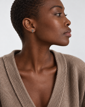 Fleur-de-Lis earrings worn at natural proportions; AI-generated brand photograph