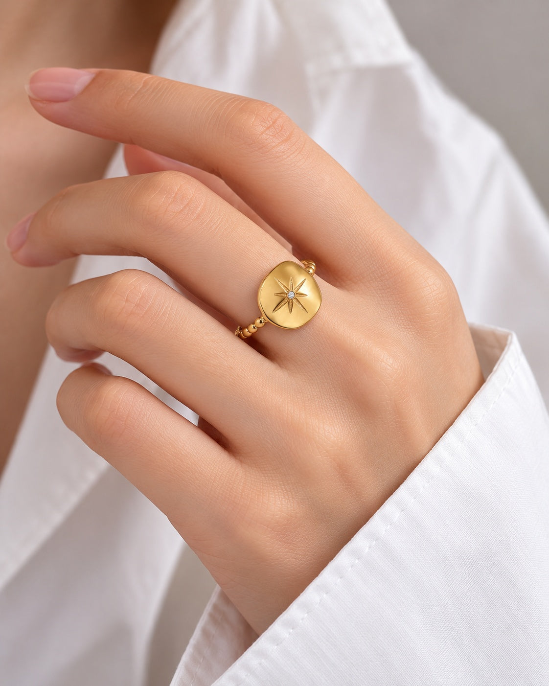 Eight-Point Signet ring worn at natural scale; AI-generated brand photograph