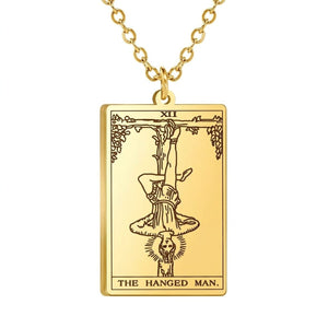 Close view of the gold The Hanged Man engraved tarot-card pendant.