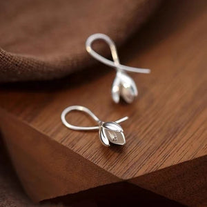 Silver-tone leaf drop earrings in a detail product view