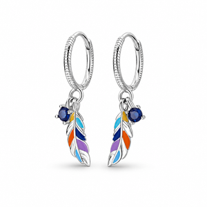 Silver-tone colored feather hoop earrings on a warm-white background
