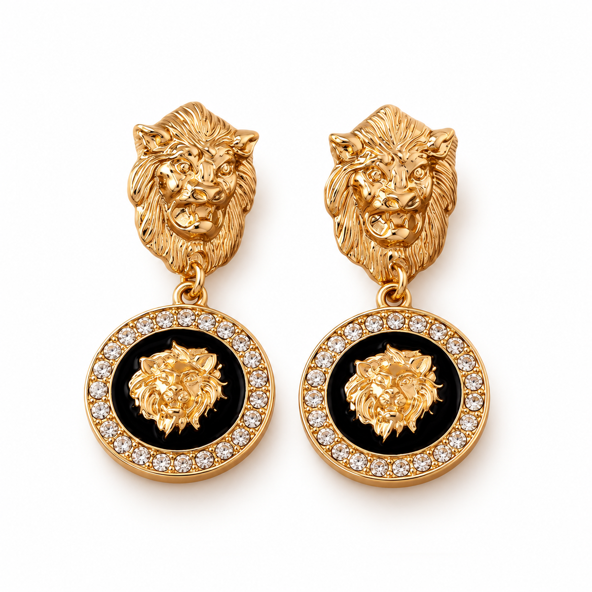 Gold-tone lion medallion earrings on a warm-white background