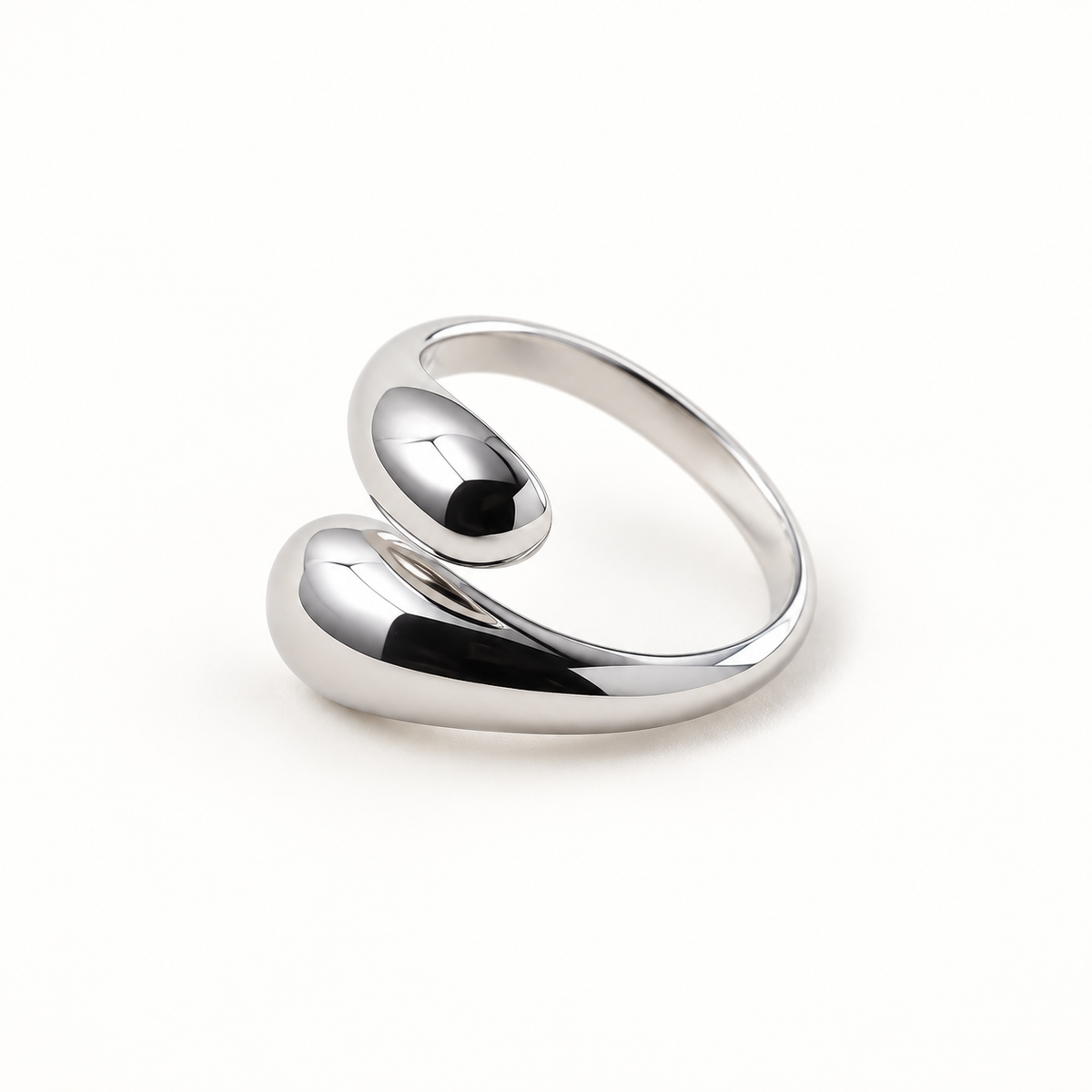 Silver-tone twin waterdrop ring on a warm-white background