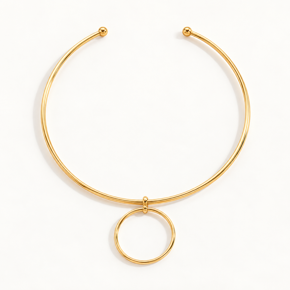 Gold-tone circle collar necklace on a warm-white background