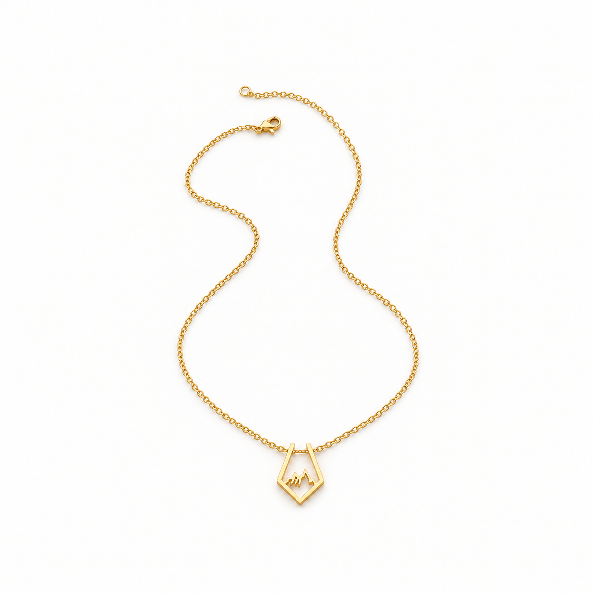 Gold-tone mountain necklace on a warm-white background