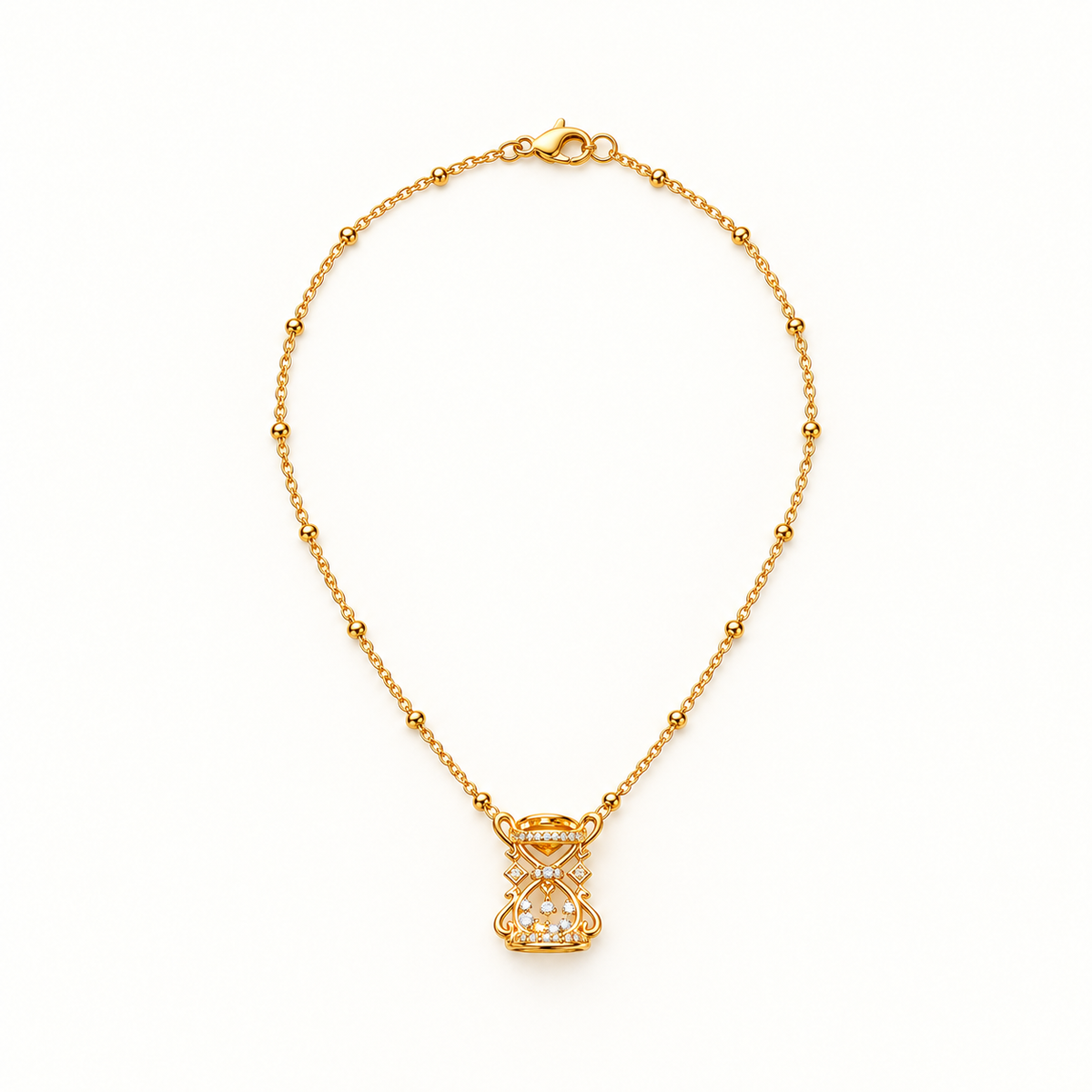 Gold-tone hourglass necklace on a warm-white background