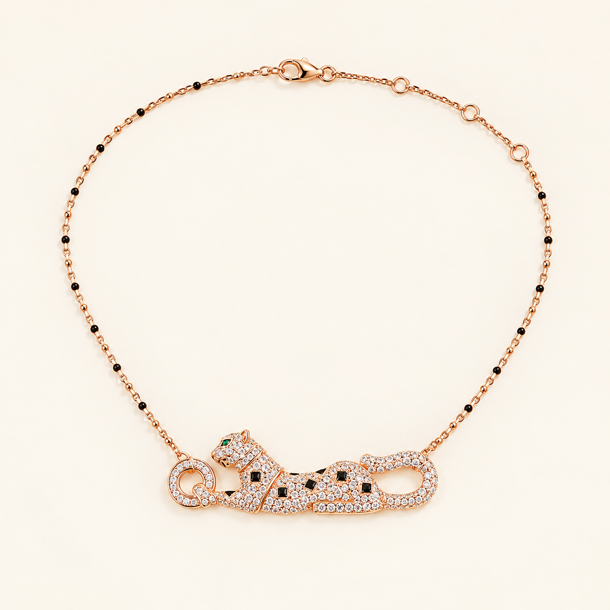 Rose Gold-tone reclining panther necklace on a plain warm-white background