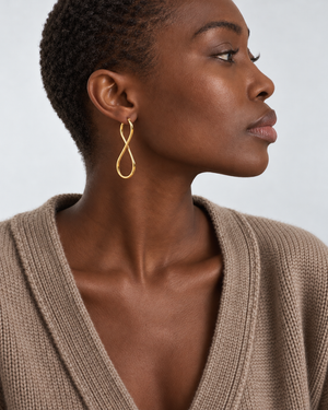 Infinity Hoop earrings worn at natural proportions; AI-generated brand photograph