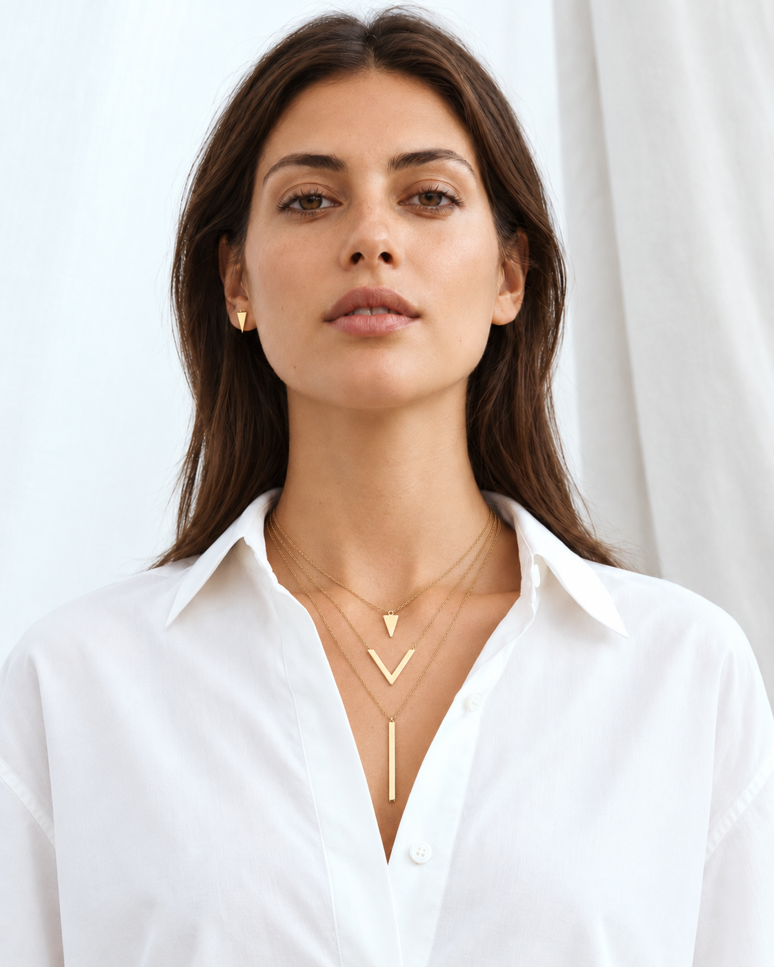 Gold-tone geometric necklace worn at natural scale; AI-generated brand photograph