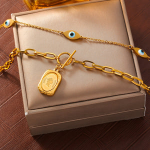 Gold-tone eye and coin necklace in a detail product view