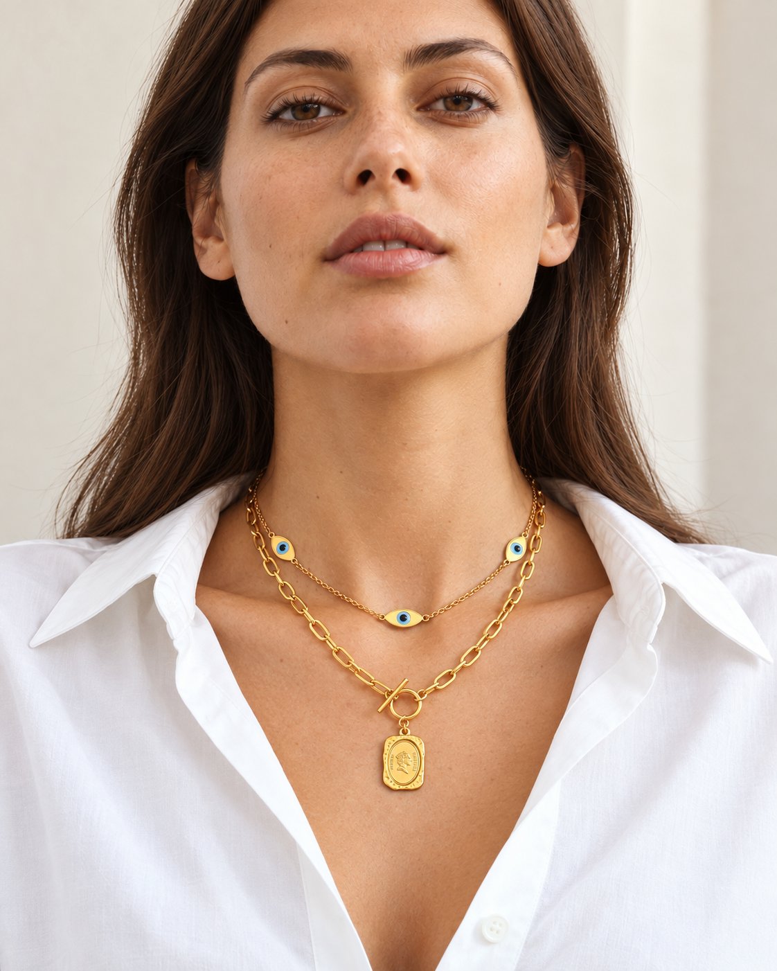 Gold-tone eye and coin necklace worn at natural scale; AI-generated brand photograph