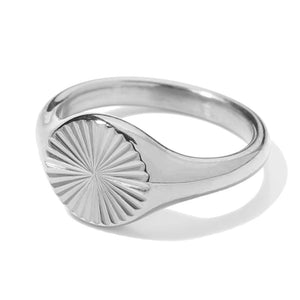 Silver-tone ring with radiating lines across an oval face