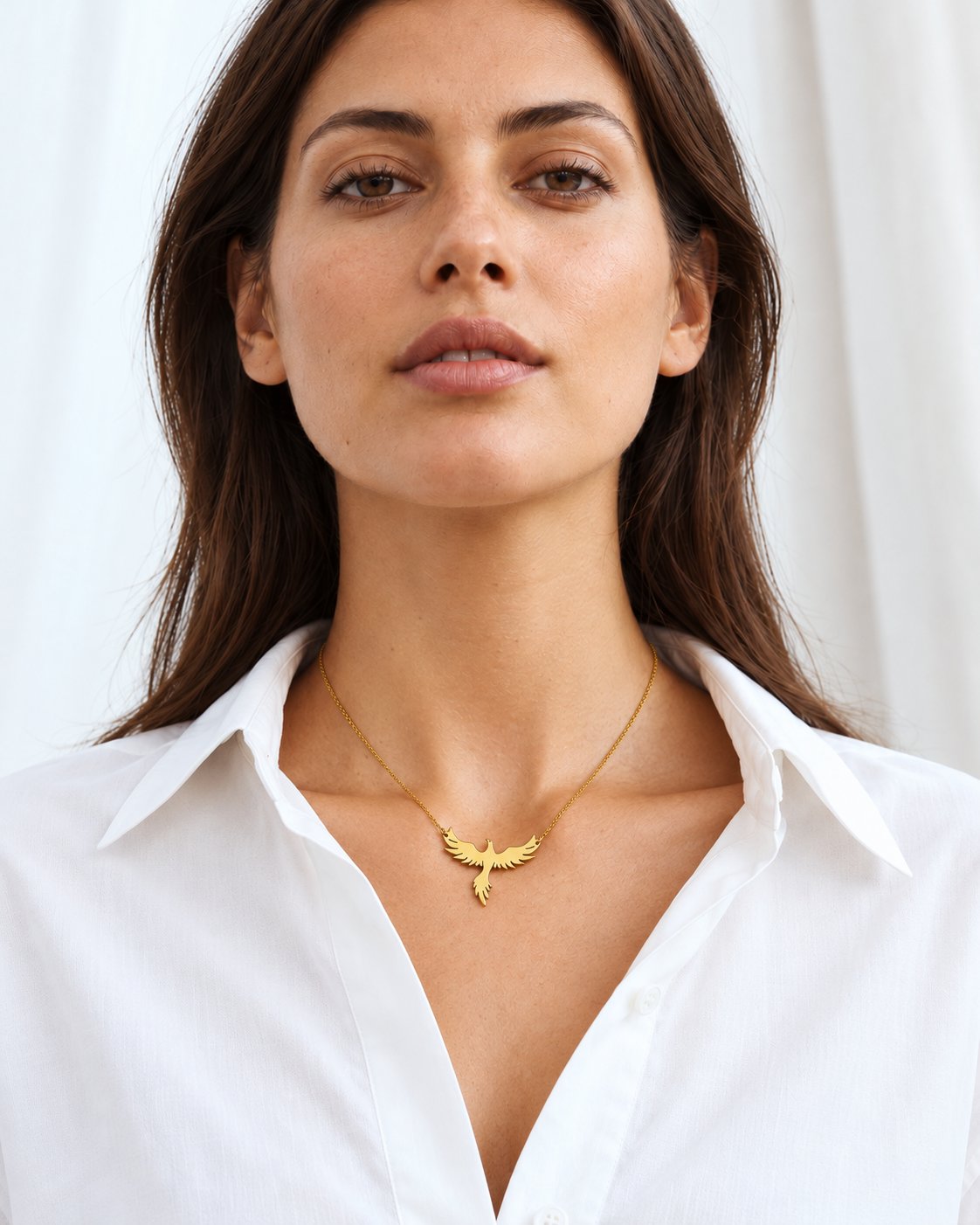 Gold-tone phoenix necklace worn at natural scale; AI-generated brand photograph