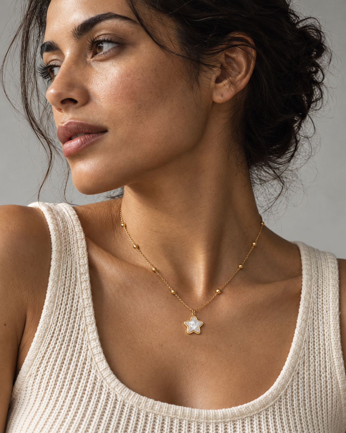 Gold-tone star necklace worn at natural scale; AI-generated brand photograph