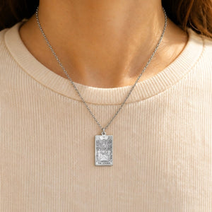 Silver The Lovers tarot-card pendant necklace worn over a cream knit top.