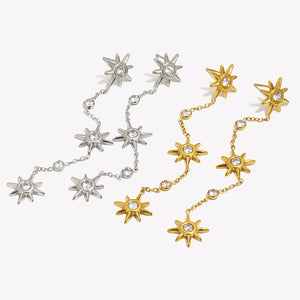 Gold-tone and silver-tone three-star chain drop earrings shown together